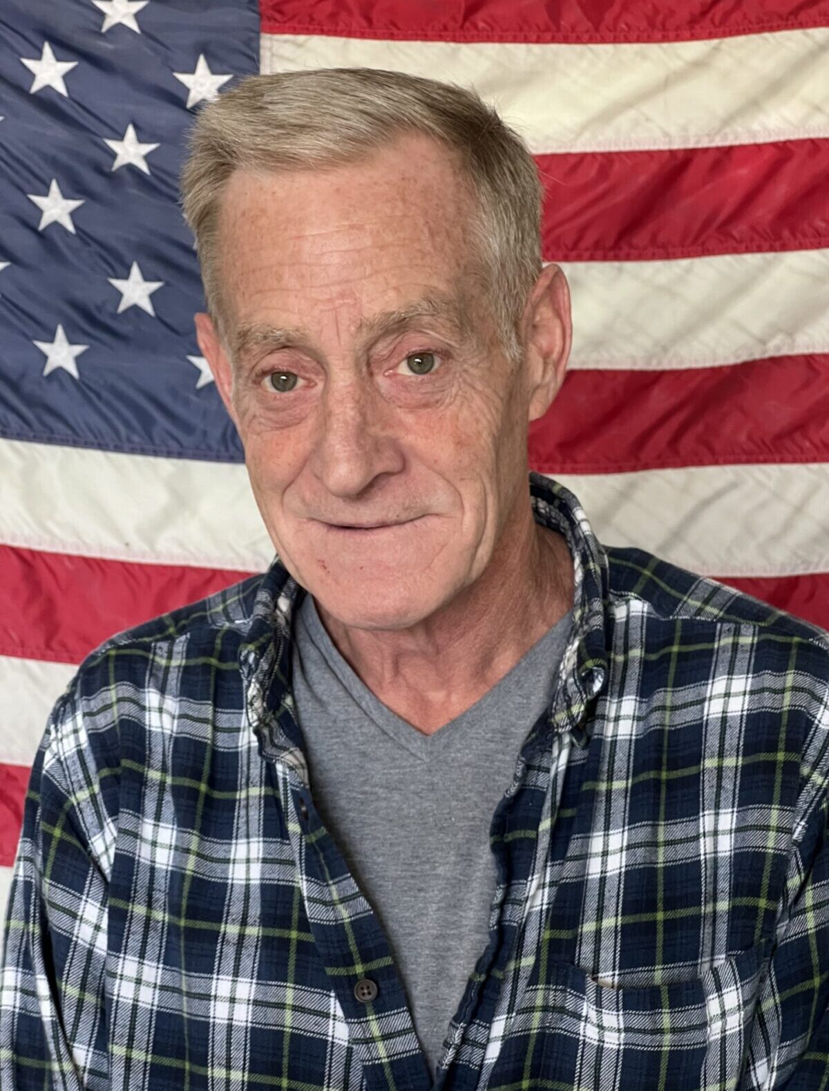 Man in front of American flag